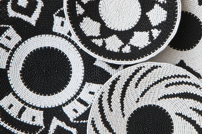 Woven baskets as a background made with black and white plastic coated telephone wire by African craftsmen